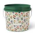 Green bucket with floral pattern on a white background.