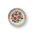 A small round ceramic plate with a white background, featuring a colorful hand-painted floral design in the center and a decorative border with gold detailing, set against a plain white background.