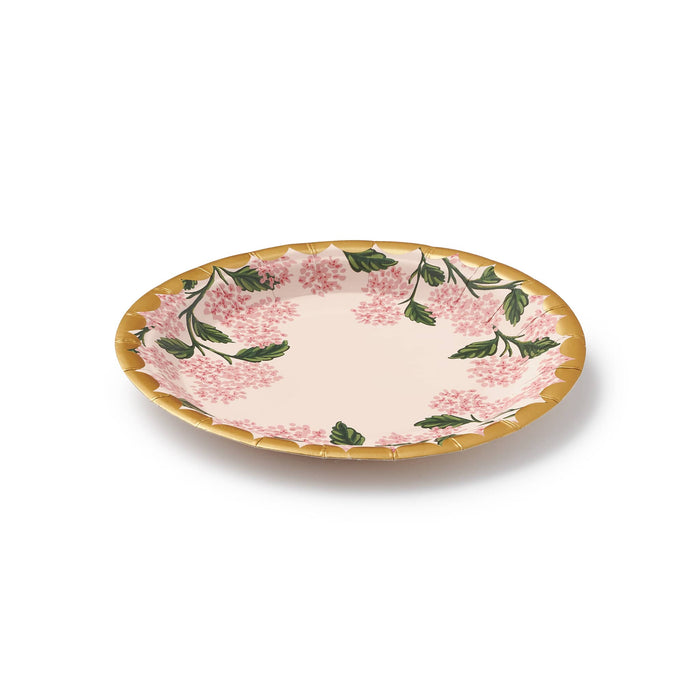 Pink hydrangea floral plate with gold foil scalloped edge, side view, on a white background.