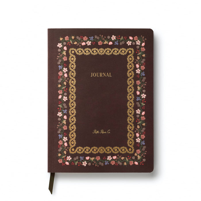 A dark burgundy softcover journal with a decorative floral border and gold foil detailing, featuring the word 'JOURNAL' and the brand 'Rifle Paper Co.' on the cover, shown on a white background.