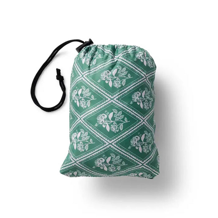 Green drawstring bag with white floral pattern on a white background.