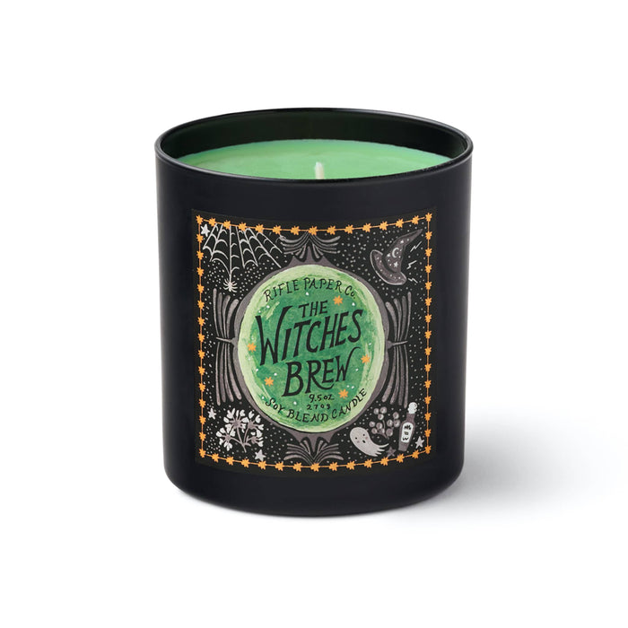 A black candle jar with a green wax fill and a decorative front label reading 'Rifle Paper Co. The Witches Brew,' shown on a white background.