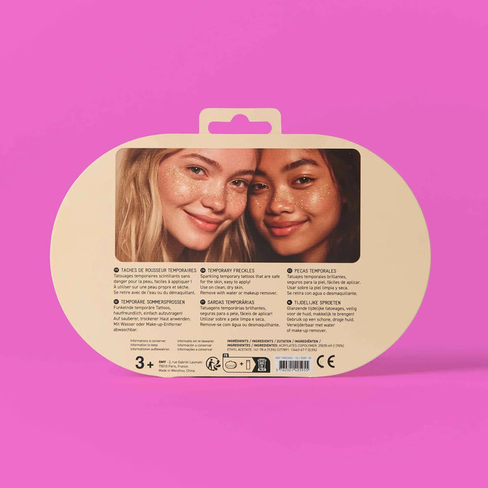 Back of packaging for gold freckle temporary tattoos with two models' faces on a pink background.