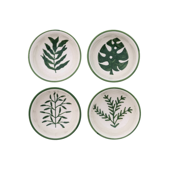 Four small round cream stoneware bowls arranged in a 2x2 grid, each decorated with a different green botanical leaf pattern and a dark green rim.
