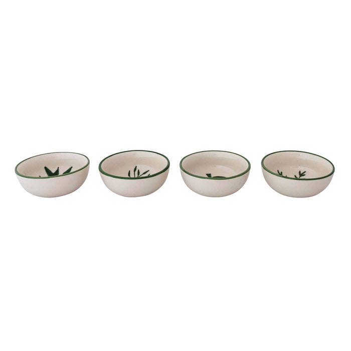 Four small ceramic bowls lined up in a row, featuring a warm cream interior and exterior, a dark green rim, and a green leaf motif printed inside.