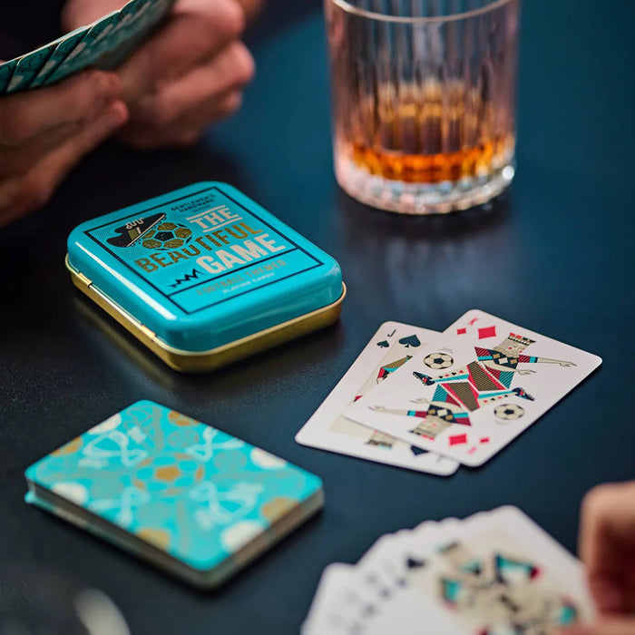 Gentlemen's Hardware The Beautiful Game collection soccer-themed playing cards with turquoise tin packaging, with cards in play.