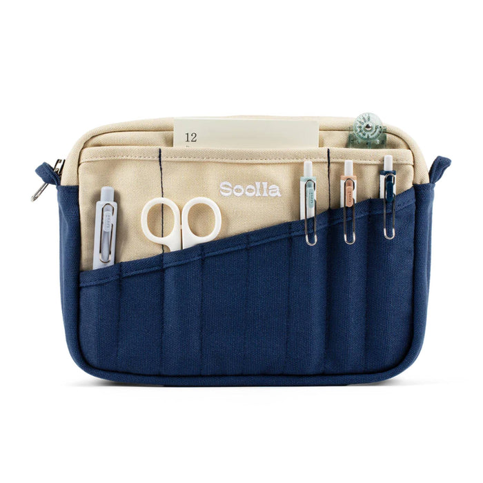 Blue and beige canvas pouch with scissors, pens and paper, front view, on a white background.