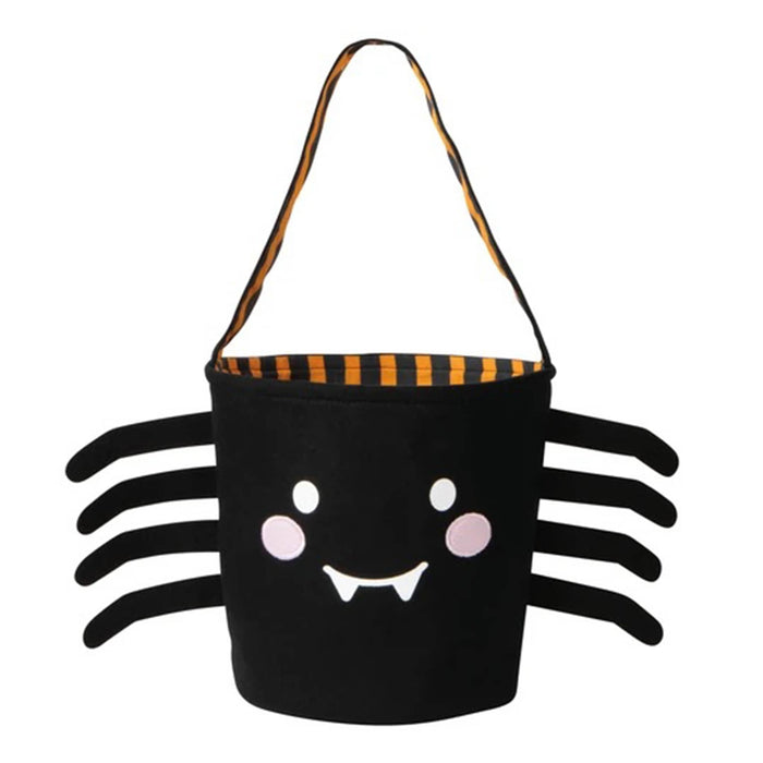 A black spider-shaped Halloween bucket bag with a smiling face, pink cheeks, and eight black legs, featuring an orange and black striped handle on a white background.