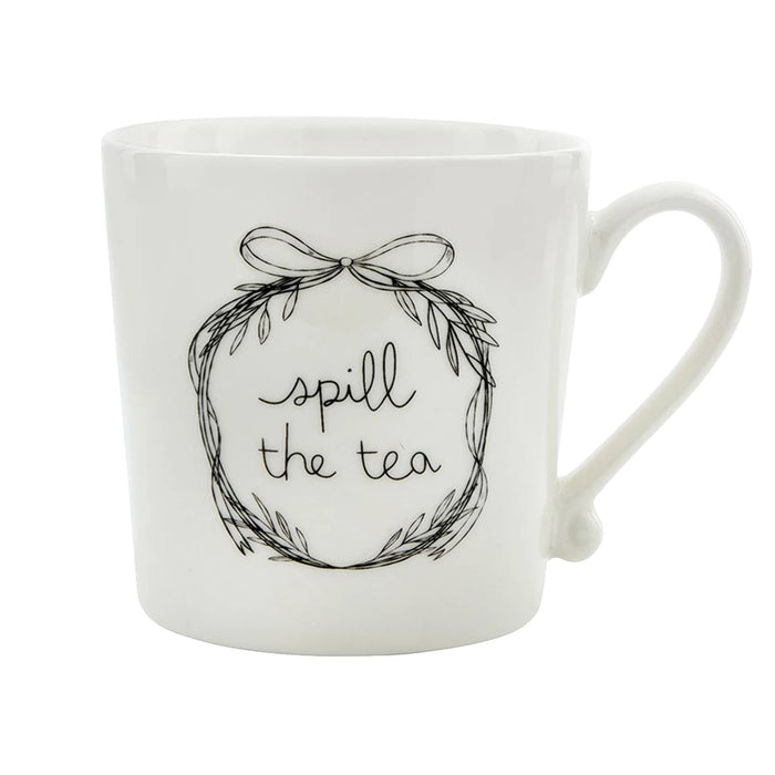 White mug with 'spill the tea' text and decorative wreath on a white background.