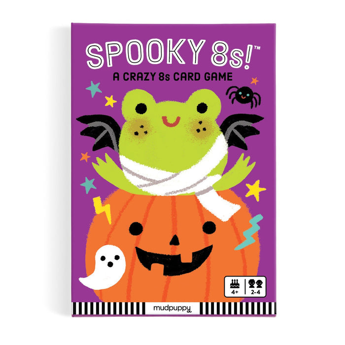 Spooky 8s! A Crazy 8s Card Game box by mudpuppy, featuring a purple background with a cartoon frog mummy sitting on a jack-o'-lantern pumpkin, with small Halloween icons including a ghost, spider, and stars.