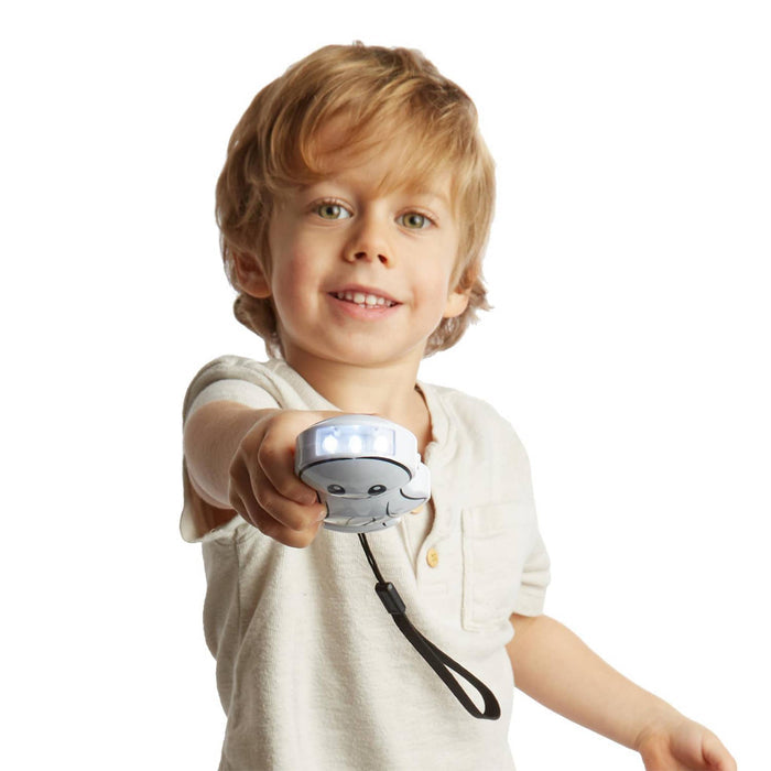 Child holding a small flashlight on a white background.