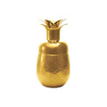 Gold tone pineapple-shaped cocktail shaker on a white background.