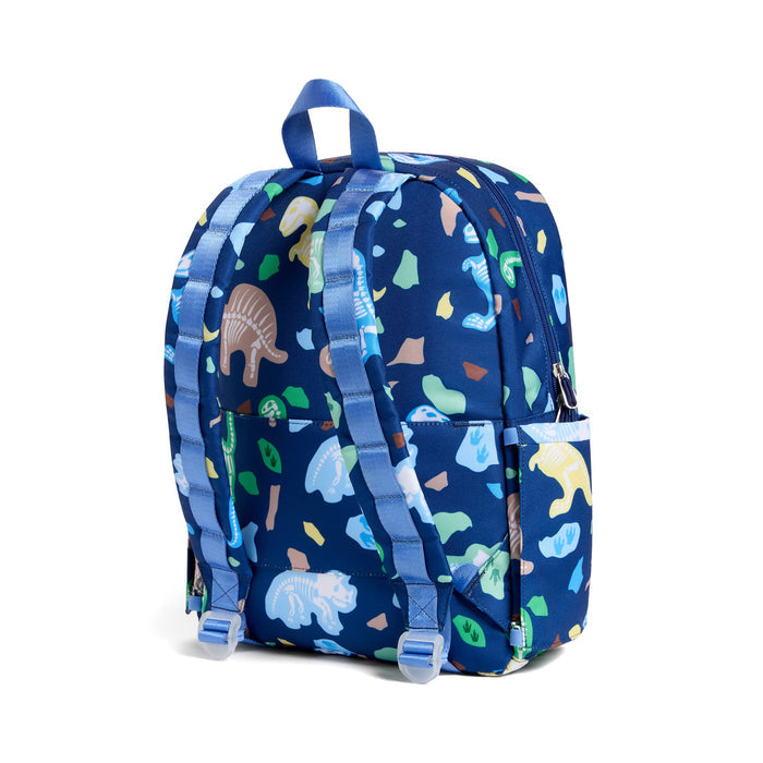 A navy blue backpack with a colorful dinosaur pattern, featuring light blue adjustable shoulder straps and a top carry handle, back angle view shown against a plain white background.