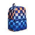 A backpack with a navy blue checkerboard pattern on a blue and orange gradient backdrop, featuring a front zippered pocket and a small 'STATE' label, front angle view on a plain white background.