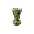 A small ceramic bud vase with a fluted, lotus-like top and a rounded base, covered in a speckled green and brown glaze, isolated on a white background.