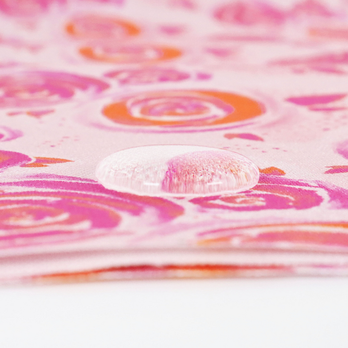 This printed WPC-Lite is of watercolor rose in pink and orange. This photo shows a water drop on the fabric.