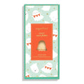 A packaged candy bar in a tall rectangular box with a mint green and orange design, printed with white cartoon ghosts and gold stars. The center label reads 'sugarfina' and 'sweet corn flakes' with a clear window showing a single corn-flake candy bar inside.