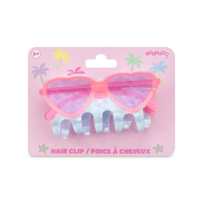 Hair clip with heart-shaped sunglasses design on a pink packaging background.