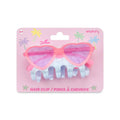 Hair clip with heart-shaped sunglasses design on a pink packaging background.