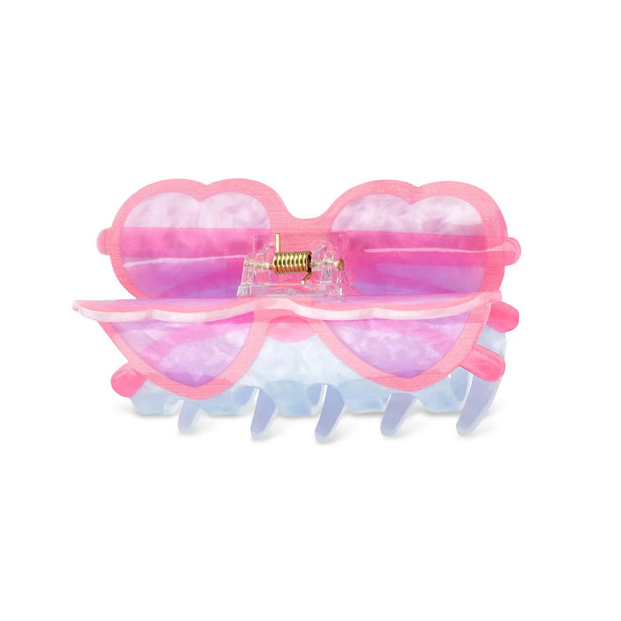 Hair claw clip with heart-shaped sunglasses design, top view, on a white background.