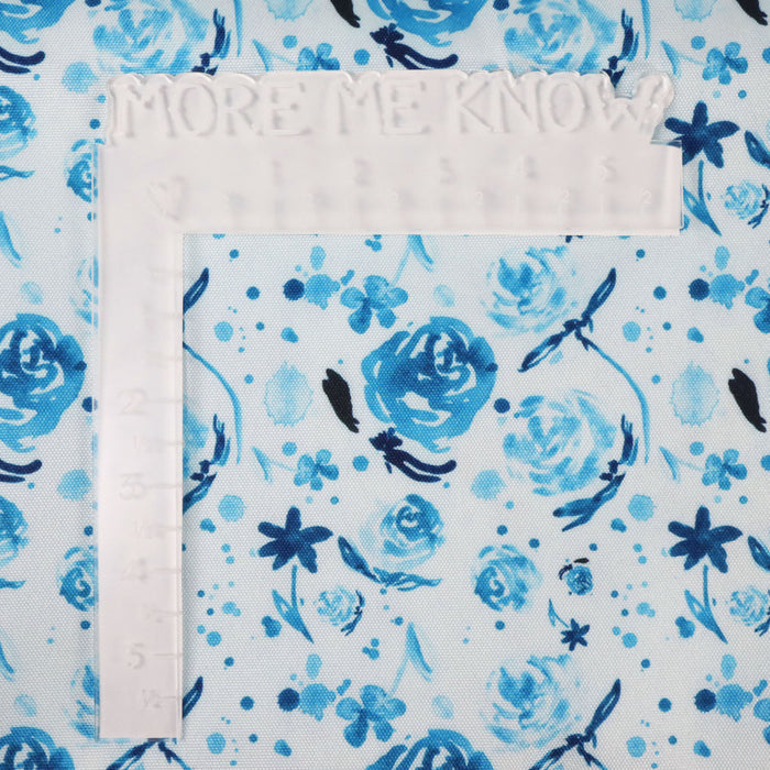 This printed WPC-Lite is of watercolor flowers in teal tones. This photo shows a white L shaped ruler for scale.