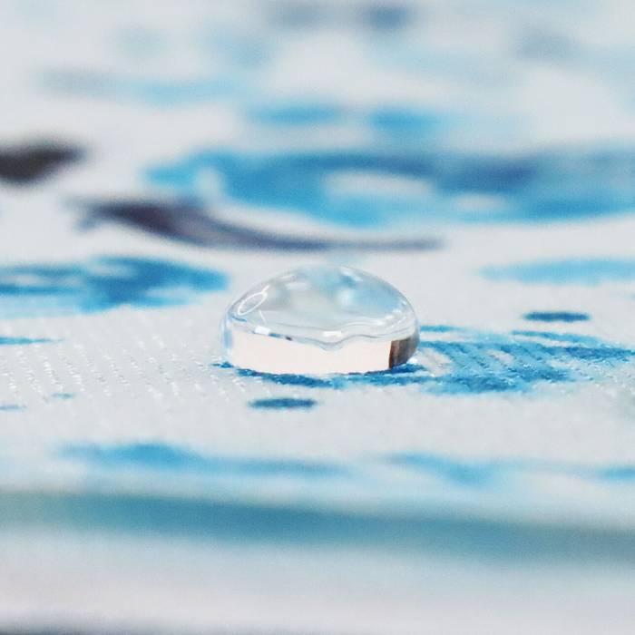 This printed WPC-Lite is of watercolor flowers in teal tones. This photo shows a water drop on the fabric.