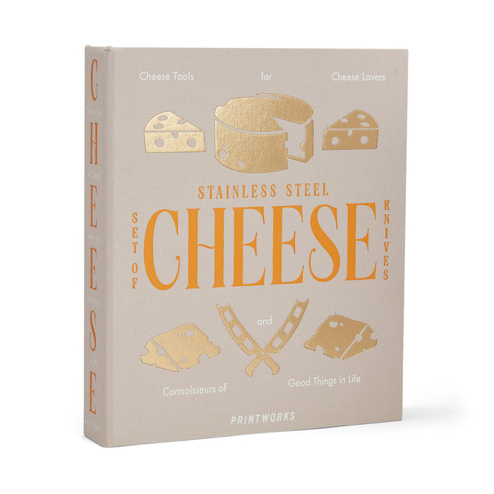 Printworks The Essentials Cheese Tools for Cheese Lovers, set of 3 stainless steel cheese knives in beige book box packaging, front and side angle view.