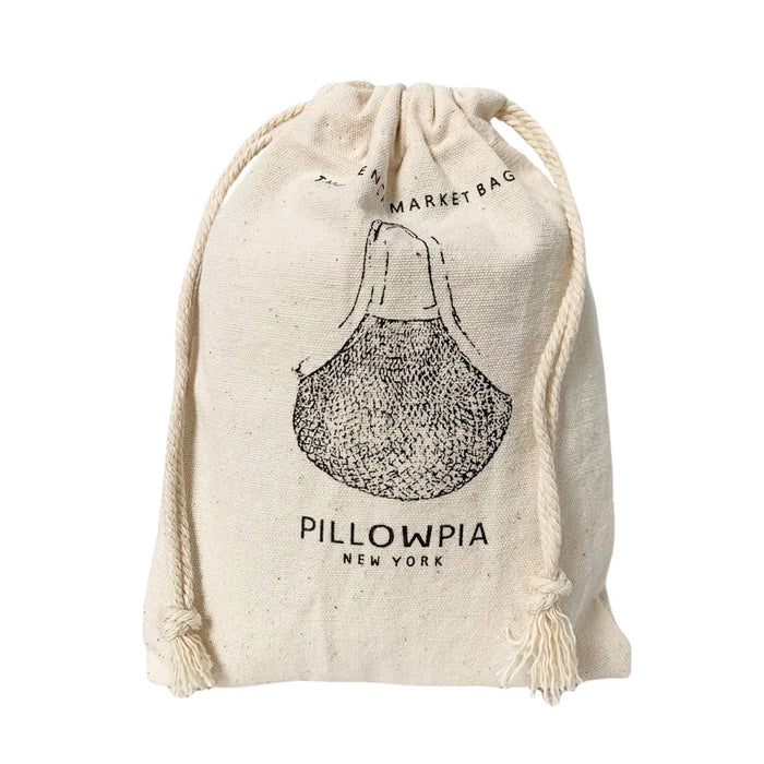 A natural canvas drawstring bag with a black printed illustration of a net bag and the text 'PILLOWPIA NEW YORK' and 'FRENCH MARKET BAG' on a white background.