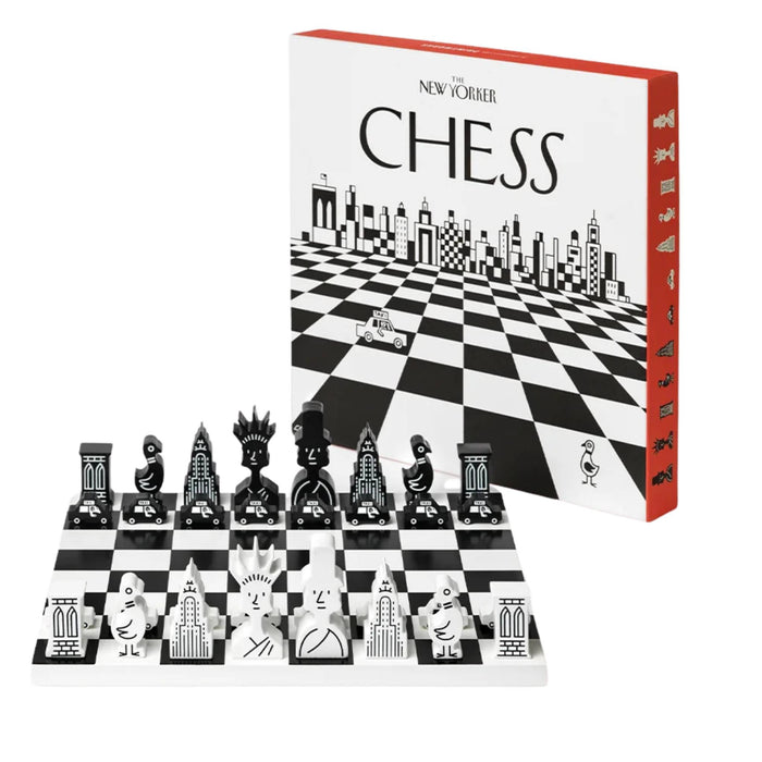 A New Yorker Chess set with black and white checkered pieces and a matching black-and-white chessboard, shown in front of its white and red product box on a light gray background.