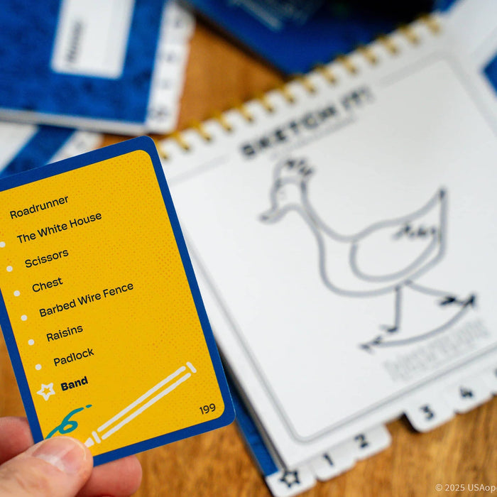 Card with text and a drawing of a roadrunner next to a playing card with words, on a wooden surface.