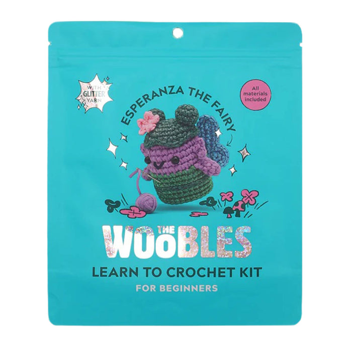 Front of teal blue pouch packaging for The Woobles Esperanza the Fairy beginner crochet kit, on a white background.