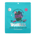 Front of teal blue pouch packaging for The Woobles Esperanza the Fairy beginner crochet kit, on a white background.