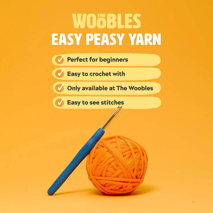 Orange yarn ball with a blue crochet hook on an orange background with 'Woobles' branding and features of their signature Easy Peasy Yarn.