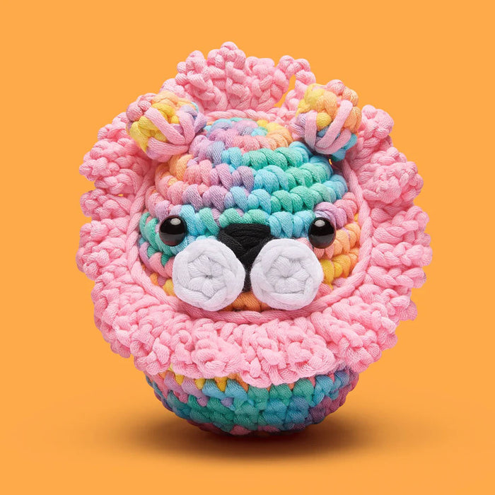 Colorful knitted lion figure on an orange background.