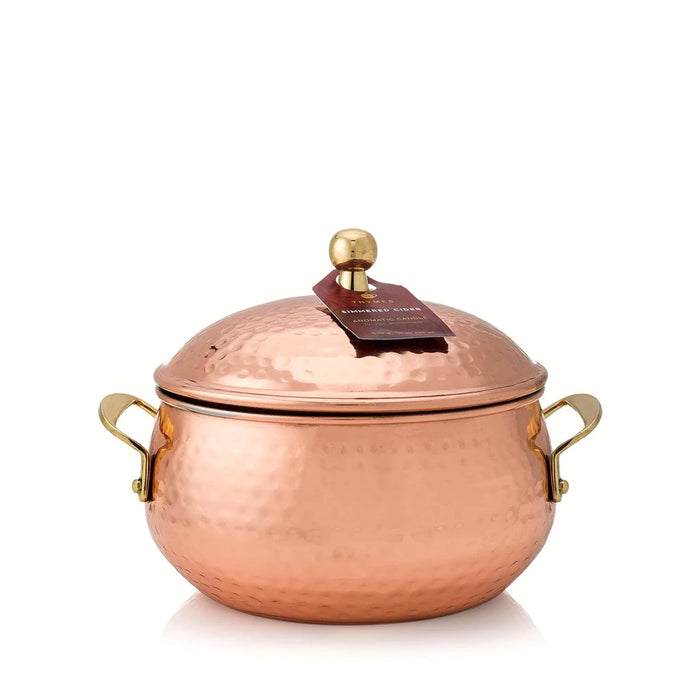 Simmered Cider scented candle in a copper pot with a lid on a white background.