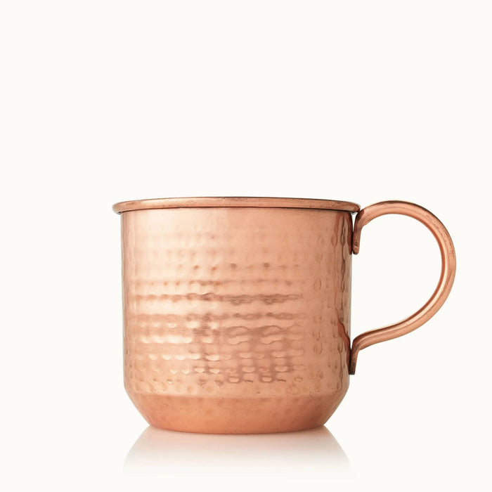 Thymes 10 ounce simmered cider scented candle in metal copper mug.