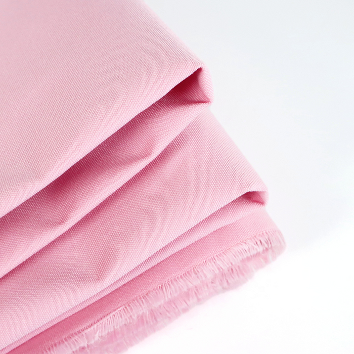 This ReNew Canvas solid is a soft pink shade that reminds us of pink cat paw pads. This photo shows the fabric folded.