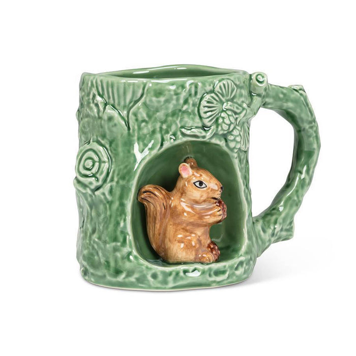 A green ceramic mug designed to look like a tree trunk, featuring a 3D brown squirrel figurine sitting inside a hollowed-out section of the mug, on a white background.