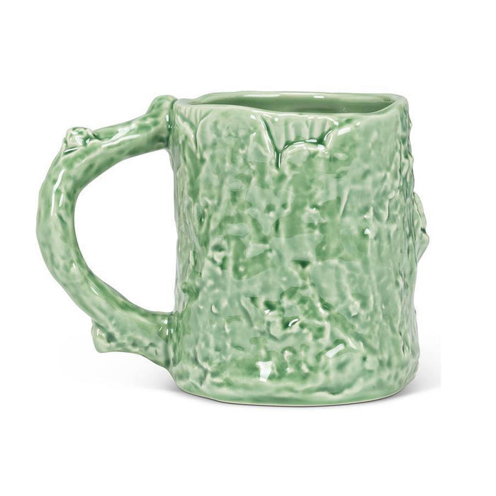 A light green ceramic mug with a textured, bark-like surface and a sculpted handle, shown on a plain white background.