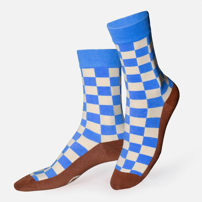 Blue and white checkered socks with brown soles on a white background.