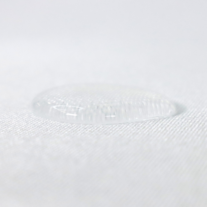 This WPC-Lite solid is in white. This photo shows a water drop on the fabric.