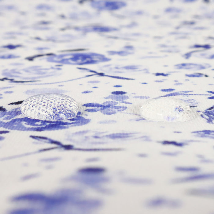 This printed WPC is of watercolor flowers in blue tones. This photo shows water droplets on the fabric.