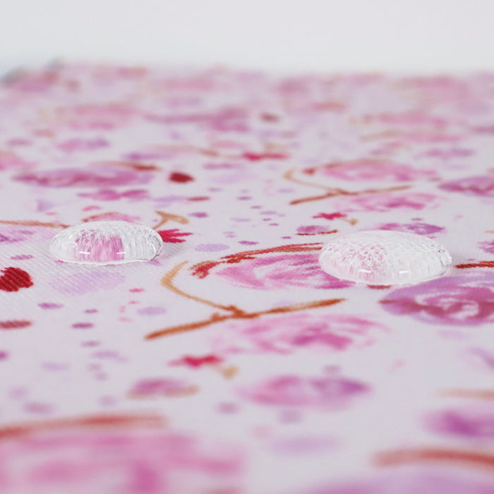 This printed WPC-Lite is of watercolor flowers in pink tones. This photo shows water droplets on the fabric.