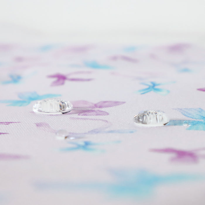 Lovely matching Ballerina Bows print on a very pale lavender/pink solid background. This photo is of water drops on the fabric.