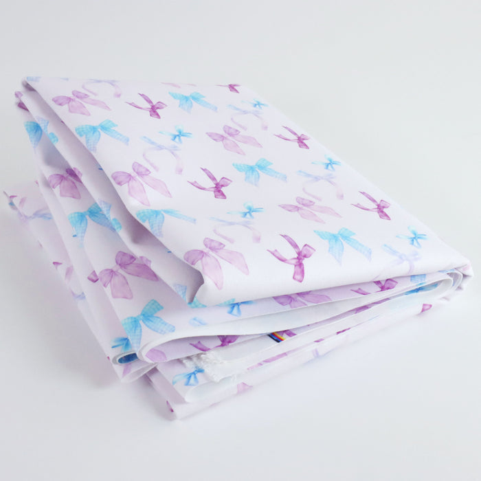 Lovely matching Ballerina Bows print on a very pale lavender/pink solid background. This photo is of the fabric folded.
