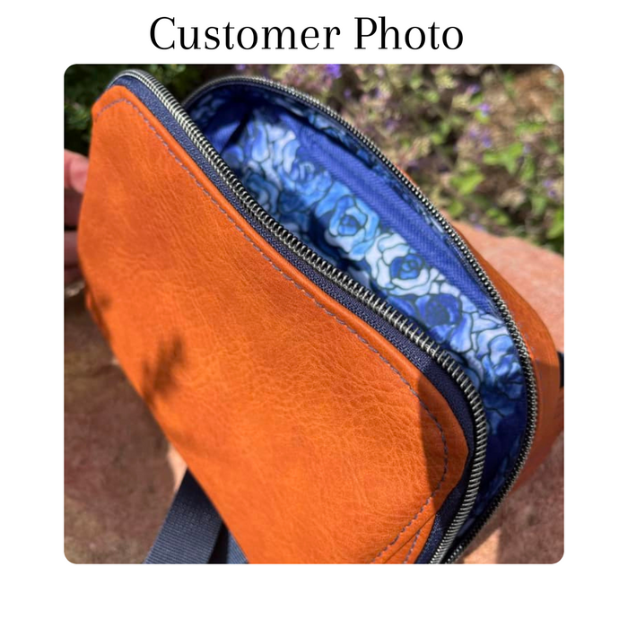 This printed WPCotton has roses that vary in shades of blue. This photo shows a handbag made of tan vinyl with the inside having this blue rose fabric.
