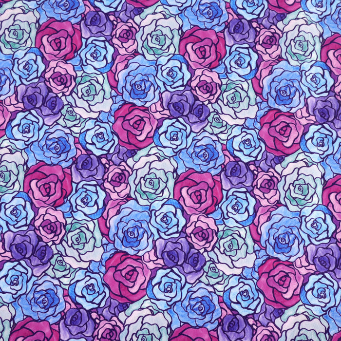 This printed WPCotton has a rose design varying in shades of blue, green, purple, and pink.