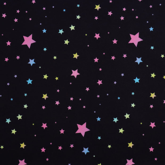 This WPCotton has pastel rainbow stars in a variety of sizes on a black background.