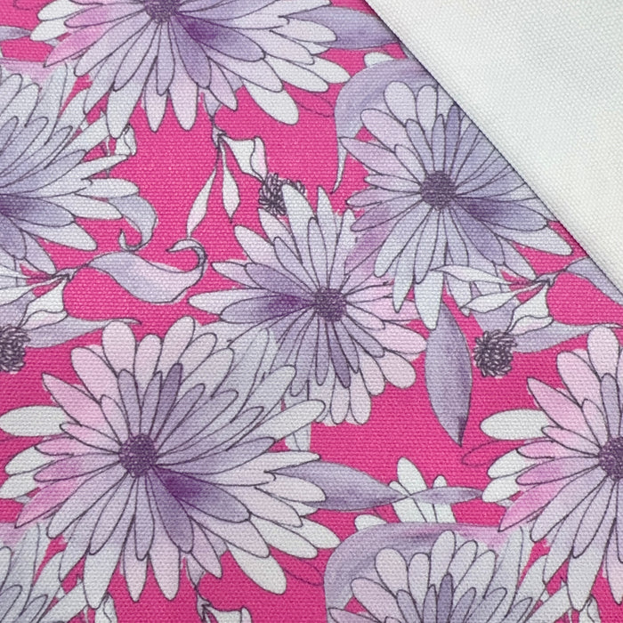 This printed WPCotton features daisy flowers in hues of pink and purple on a saturated pink background.