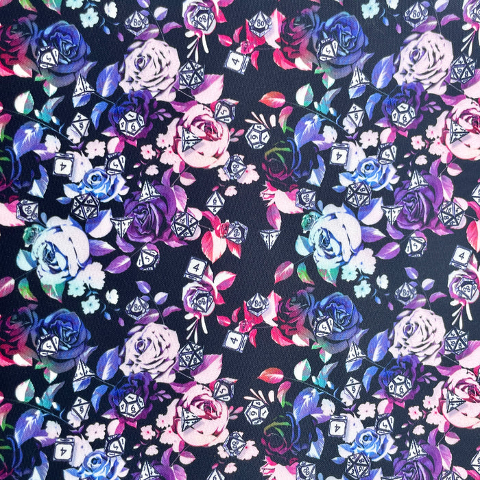 This printed WPCotton features a design with roses in a blue to pink to green ombre and different types of dice on top.
